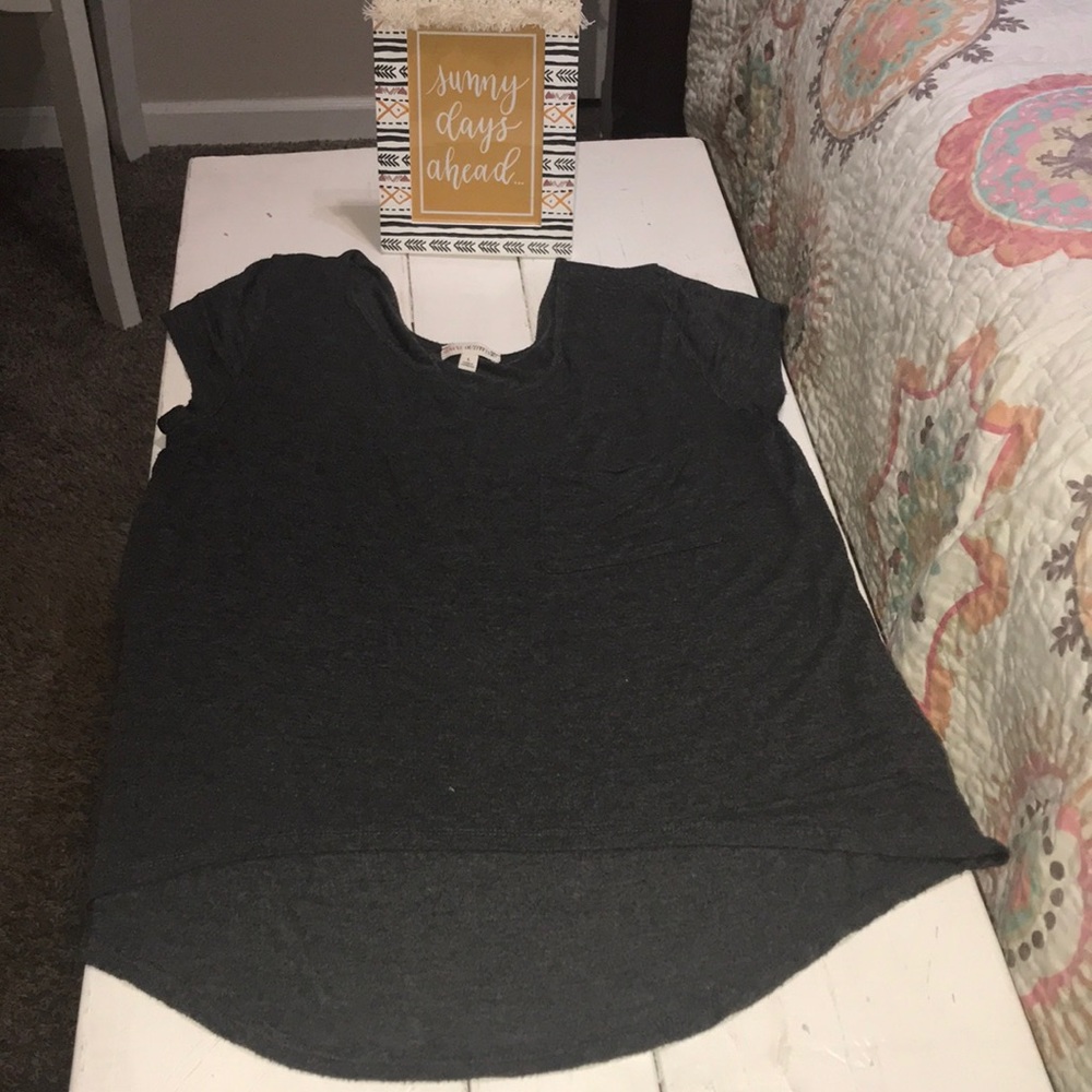 Woman’s dark grey top with breast pocket